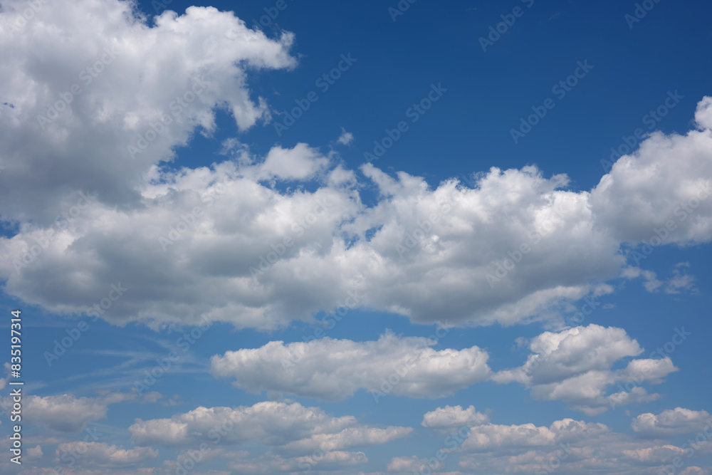 Large white beautiful clouds against the blue sky during the day.