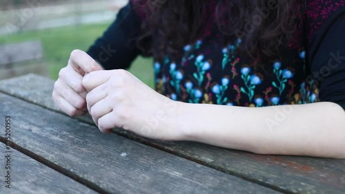 Nervous person broods, camera captures eczematous hands
