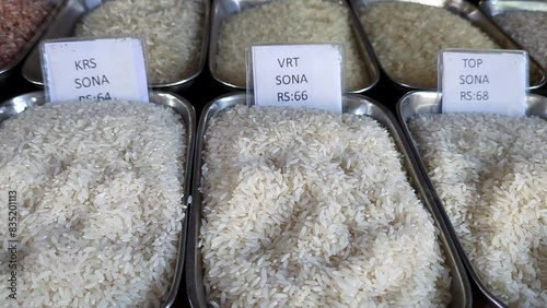Panoramic view of different types of Indian rice varieties with price tags in shop
