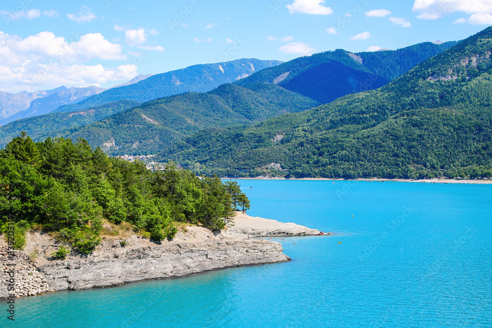 Lake of Serre-Ponçon in the French Alps, a dammed artificial reservoir gathering the water of the Durance river Lake of Serre-Ponçon in the French Alps, a dammed artificial reservoir gathering the water of the Durance river