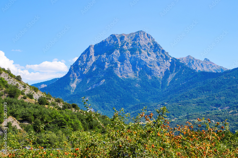 Obraz premium Peak of Morgon on the southern shore of the lake of Serre-Ponçon in the French Alps, a dammed artificial reservoir gathering the water of the Durance river
