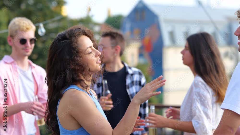 Close up of young joyful woman having fun with friends at sunset disco moving rhythmically to music dancing outdoor with boyfriend. Beautiful woman and man dancing at party Close up of young joyful woman having fun with friends at sunset disco moving rhythmically to music dancing outdoor with boyfriend. Beautiful woman and man dancing at party