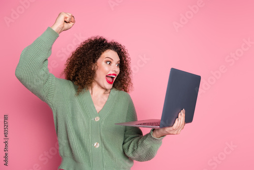 Photo of adorable cherful glad lovely woman wear trendy khaki clothes hold device isolated on pink color background photo