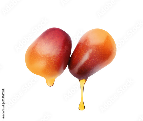 Fototapeta Naklejka Na Ścianę i Meble -  Oil dripping from palm fruits on white background