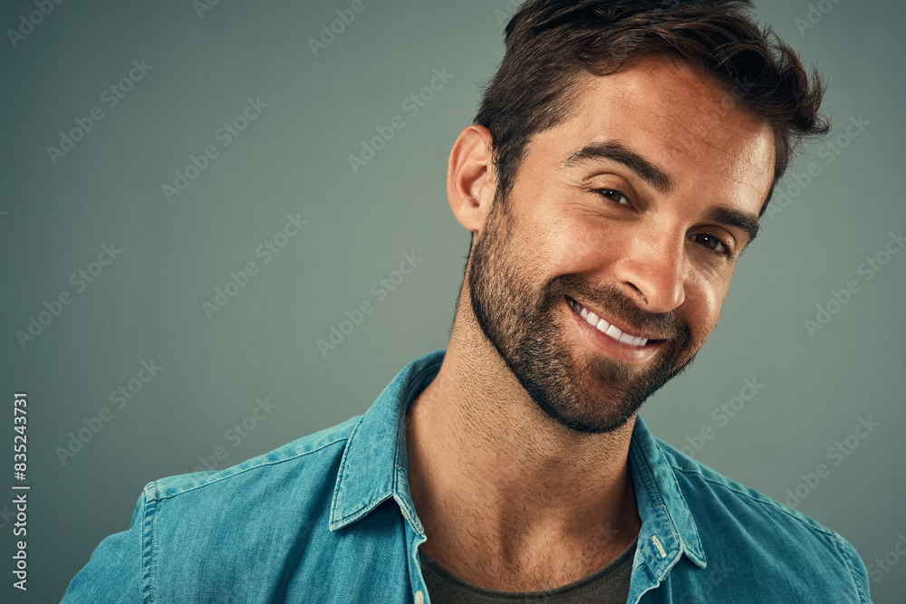 Studio backdrop, man and fashion for style in portrait, trendy or cheerful with smile. Male person, happy and outfit with confidence, retail or sale in advertisement or promotion in gray background Studio backdrop, man and fashion for style in portrait, trendy or cheerful with smile. Male person, happy and outfit with confidence, retail or sale in advertisement or promotion in gray background