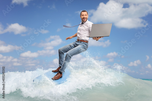 Photography Businessman with a laptop computer on top of a surfing board