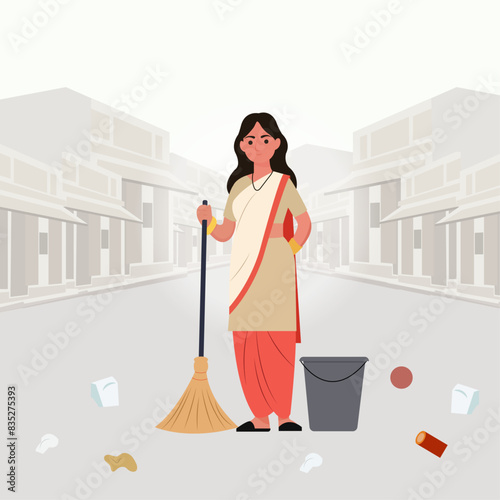 An Indian sanitation worker standing in the middle of road and cleaning the streets for a clean environment