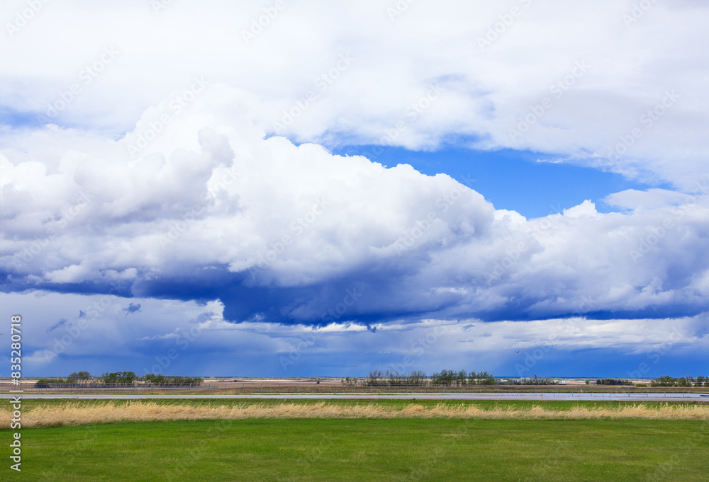 Dramatic dark cloudy sky over green plains in spring. Dramatic dark cloudy sky over green plains in spring.