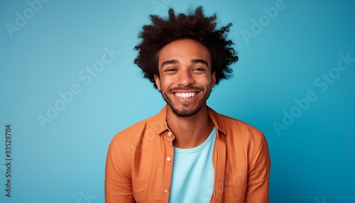 Young ugly african american man smiling on the blue background