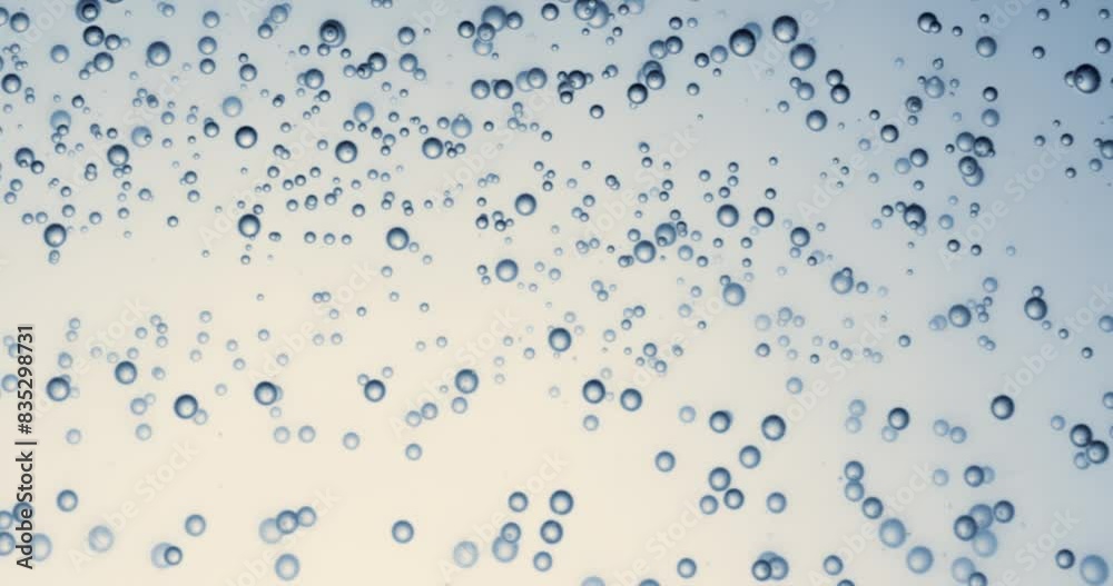 Many water bubbles in blue water close up, abstract water wave with bubbles in slow motion.
