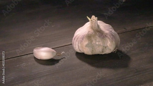 raw garlic on dark table, video