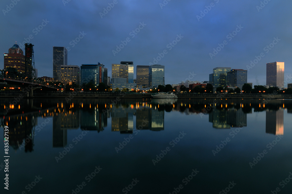Fototapeta premium City skyline and water reflections on a serene river surface
