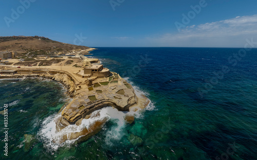 Famous touristic attraction in Gozo island the Salt Pans in  Xwejni Bay, Xwejni, Gozo island a part of the Malta islands. photo