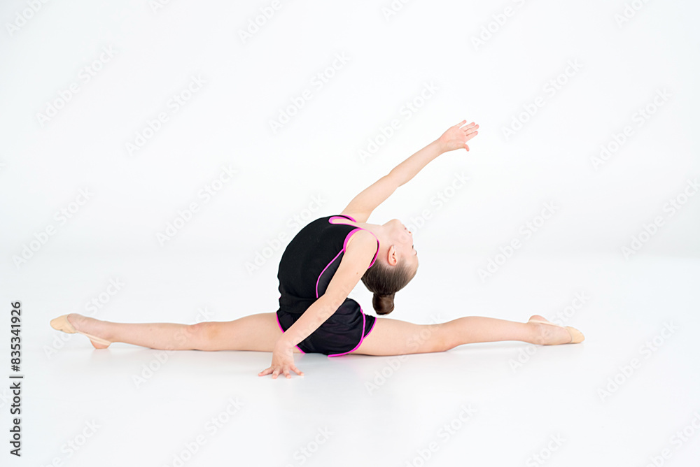 young girl doing gymnastics over white background young girl doing gymnastics over white background