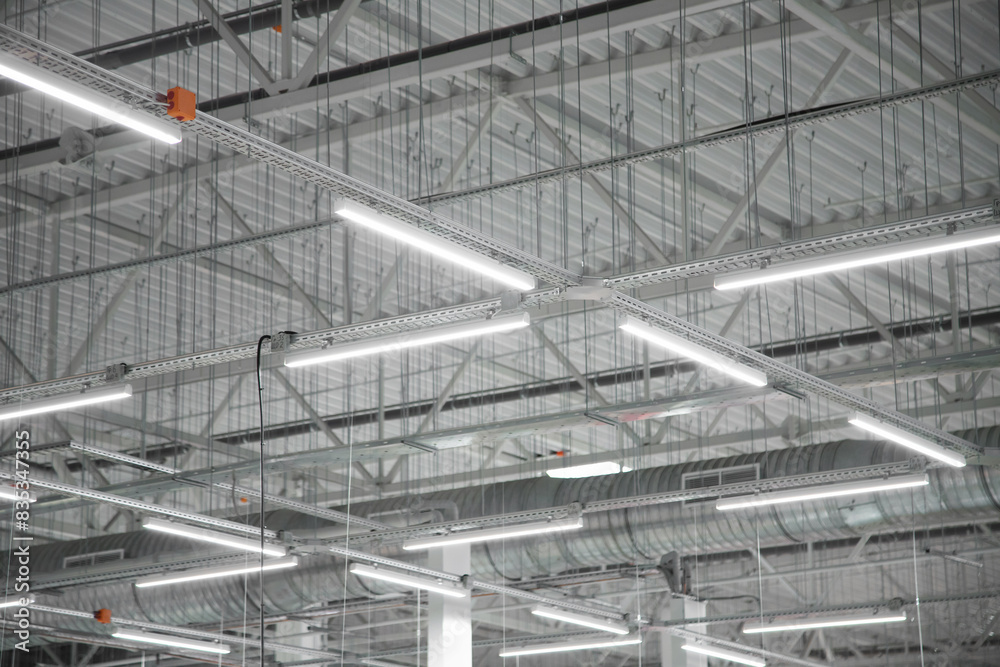 Empty factory interior or storehouse. Warehouse roof with lighting equipment