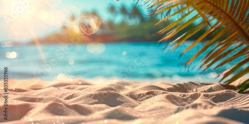 Blurred background blurred beach sand framed by palm leave photo