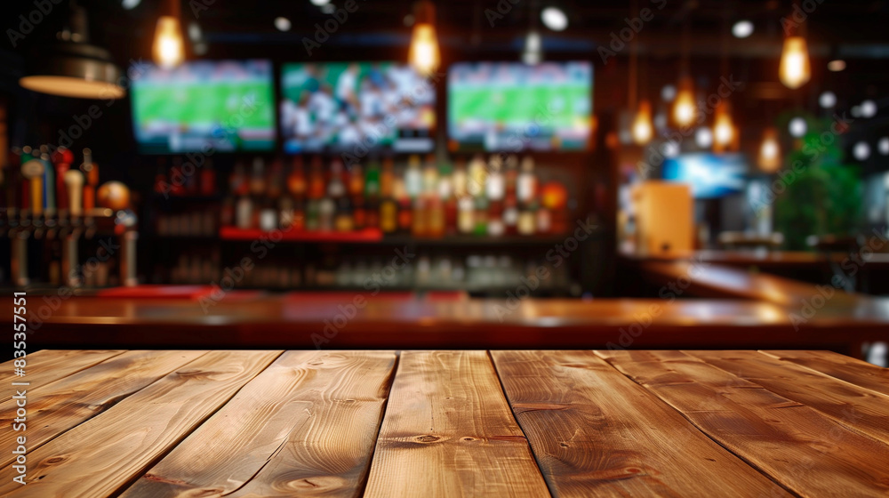 Empty wooden counter in sports bar or pub with blurred TV displays with sporting events at the bar background Empty wooden counter in sports bar or pub with blurred TV displays with sporting events at the bar background