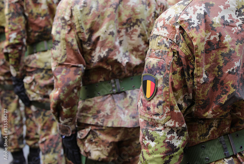 soldier of the Belgian army with the green and brown camouflage uniform and the coat of arms with the flag of Belgium on sleeve