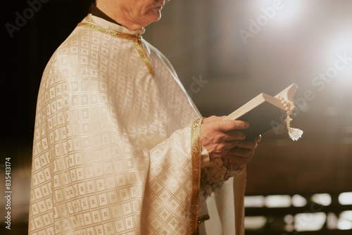 Valokuva Crop shot of unrecognizable senior Catholic priest wearing liturgical vestment r