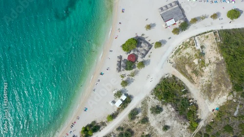 
scenic aerial view of the coastline.  white pier goes into  transparent blue sea. Vacationers on  beach. Makarska. Croatia, Dolmatia  photo