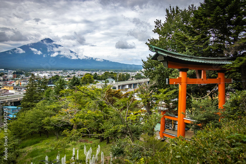 mount fuji with red torii gate in foreground, fuji covered in clouds, observation deck chureito pagoda, japan photo