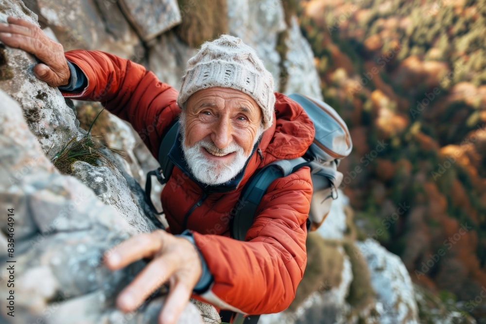 A person in red jacket reaches along a craggy rock face with autumn foliage below, displaying adventure and determination A person in red jacket reaches along a craggy rock face with autumn foliage below, displaying adventure and determination