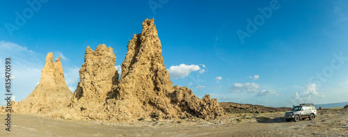 Limestone prehistoric chimneys and offroad vehicle, salt lake Abbe, Dikhil region, Djibouti photo