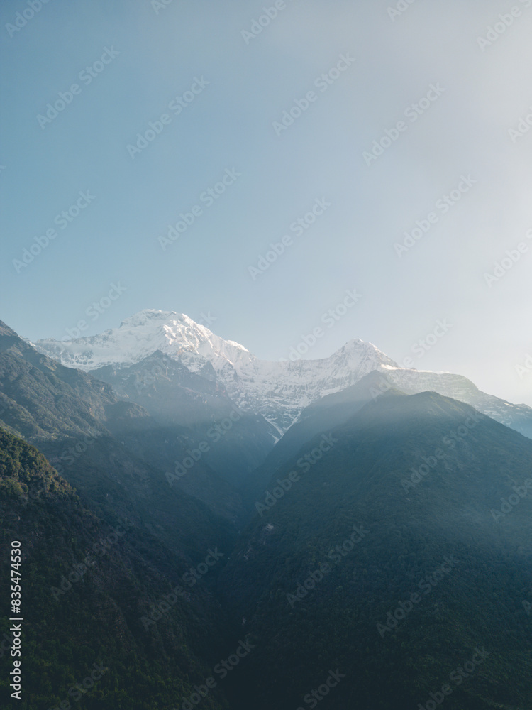 Fototapeta premium clouds over the mountains, mountains in the fog, during annapurna base camp, ghandruk, nepal