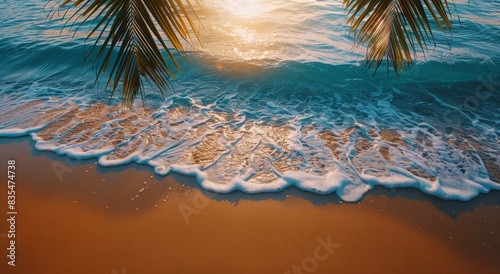 Foamy Waves Crashing on Sandy Beach at Sunset