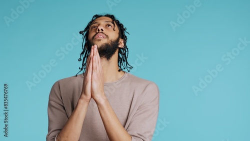 Konstfotografi Pious Middle Eastern man praying to his god, asking for forgiveness, feeling desperate