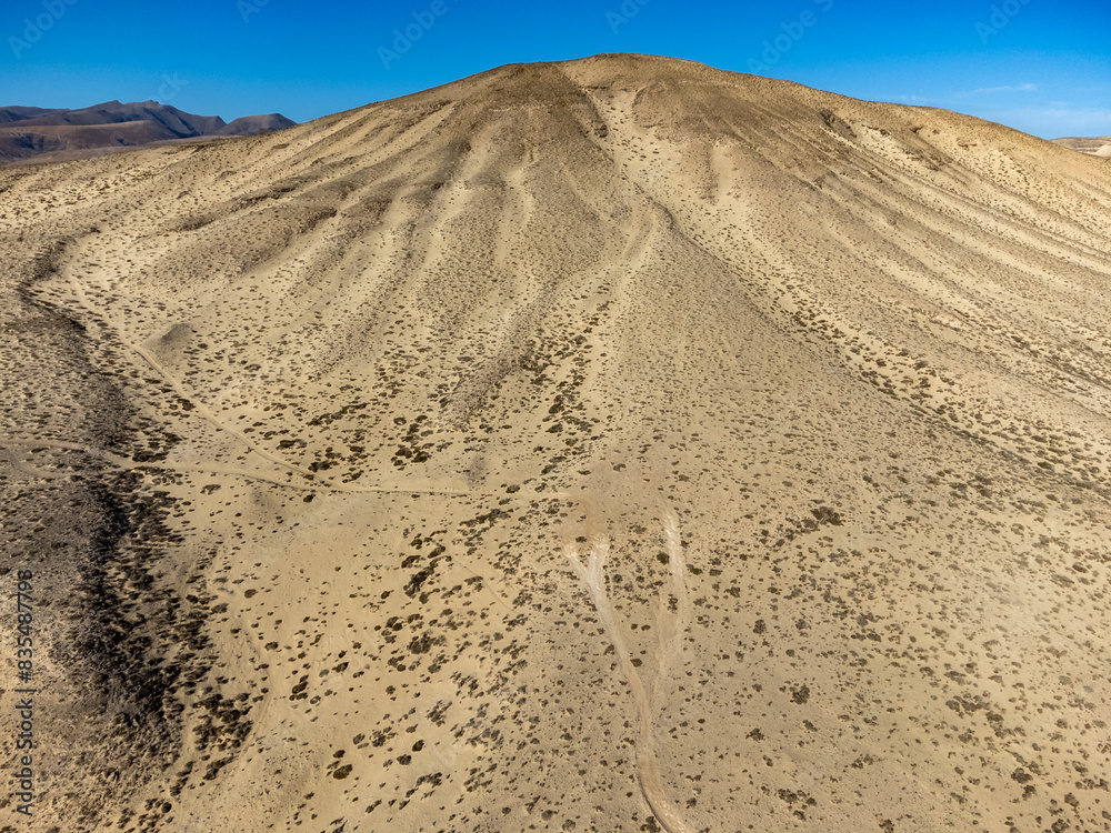 Sandy dunes and hills on Jandia peninsula near Playas de Sotavento en Costa Calma touristic resort, Fuerteventura, Canary islands, Spain Sandy dunes and hills on Jandia peninsula near Playas de Sotavento en Costa Calma touristic resort, Fuerteventura, Canary islands, Spain