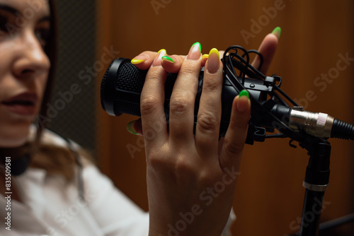 Konstfotografi Female hands holding microphone in studio