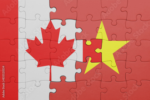 puzzle with the colourful national flag of vietnam and flag of canada.