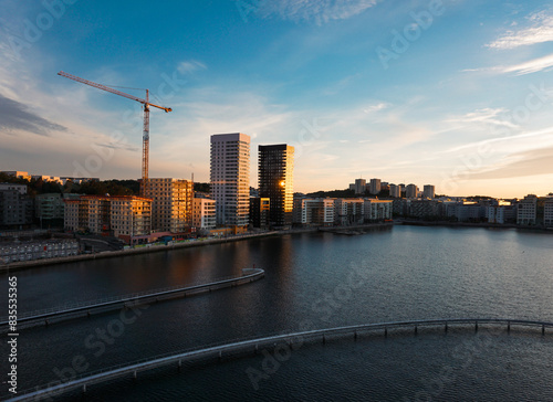 Photography High angle view of buildings by a river during sunset