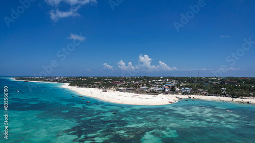 An aerial perspective of a petite african zanzibar island Kendwa Beach surrounded by vast ocean waters photo