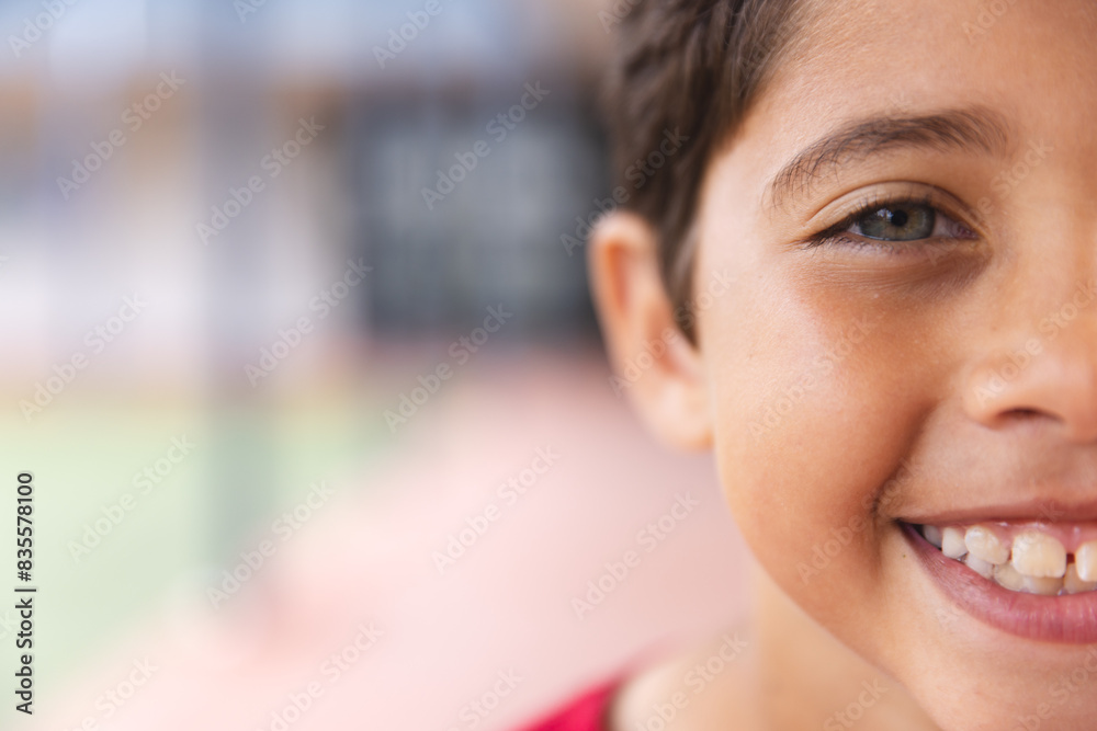 In school outdoors, young biracial male student smiling at camera with copy space In school outdoors, young biracial male student smiling at camera with copy space