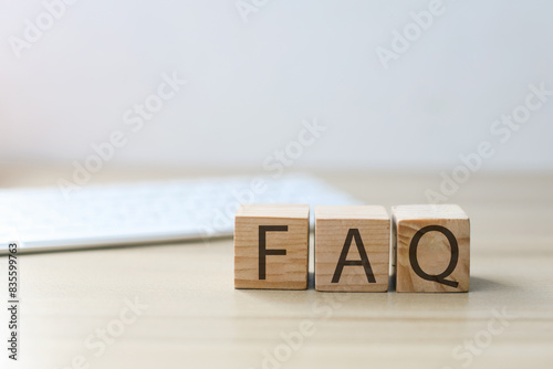 Selective Focus Of FAQ On Cube Against Blurred Keyboard Background. Frequently Asked Questions. 