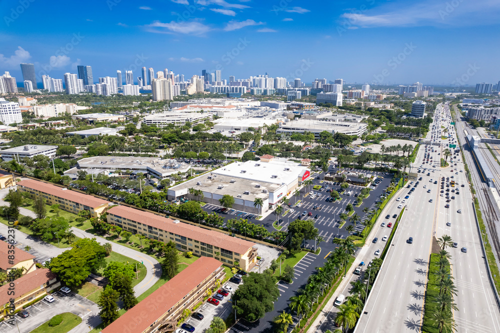 Aventura, Florida, USA - Aerial of apartment blocks and strip malls, with skyline of Sunny Isles Beach in the distance. Aventura, Florida, USA - Aerial of apartment blocks and strip malls, with skyline of Sunny Isles Beach in the distance.