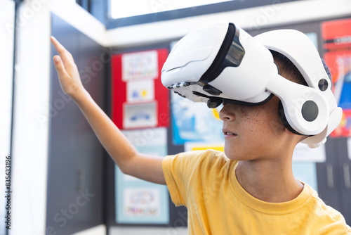 Biracial boy explores virtual reality in a school setting