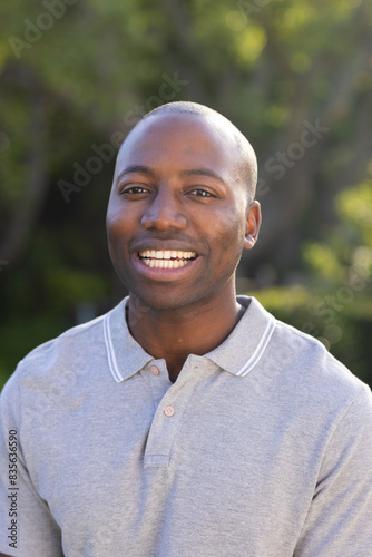 Outdoors, young African American man smiling warmly
