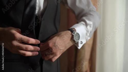 Young man put on tie. Dressing for celebration event, business meeting or wedding.