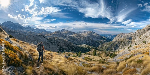 Mountain savanna landscape with man hiker in the middle of the grassland. photo