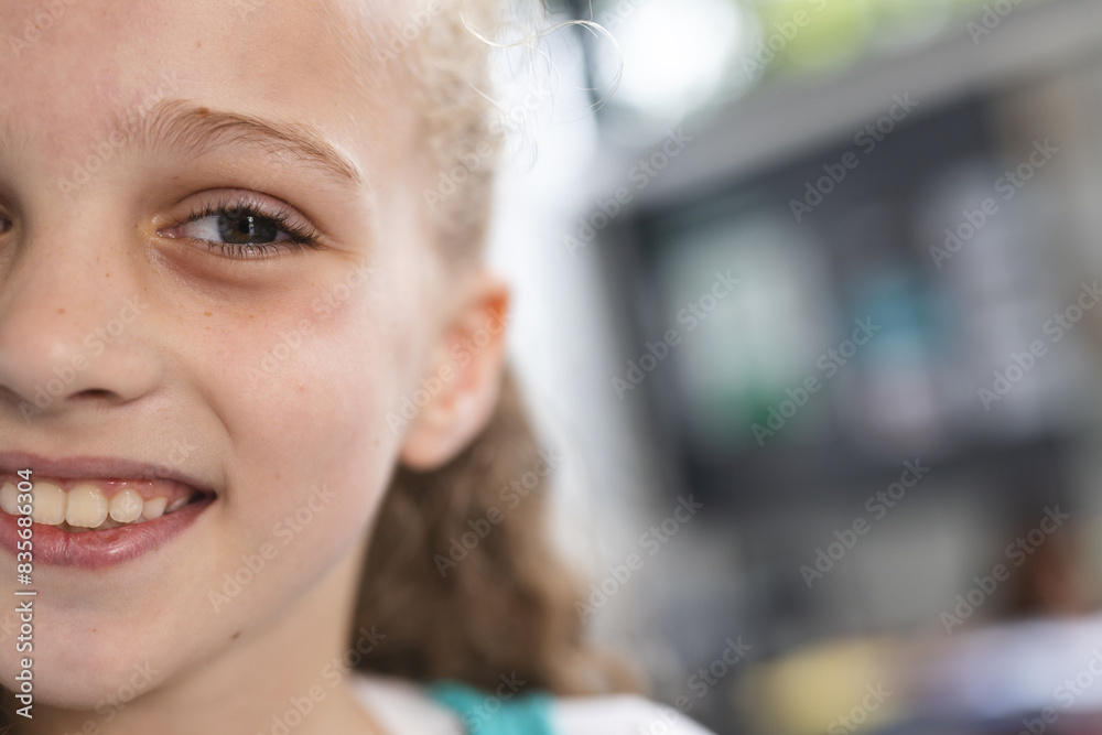 In school, young Caucasian girl is smiling with copy space in the classroom In school, young Caucasian girl is smiling with copy space in the classroom