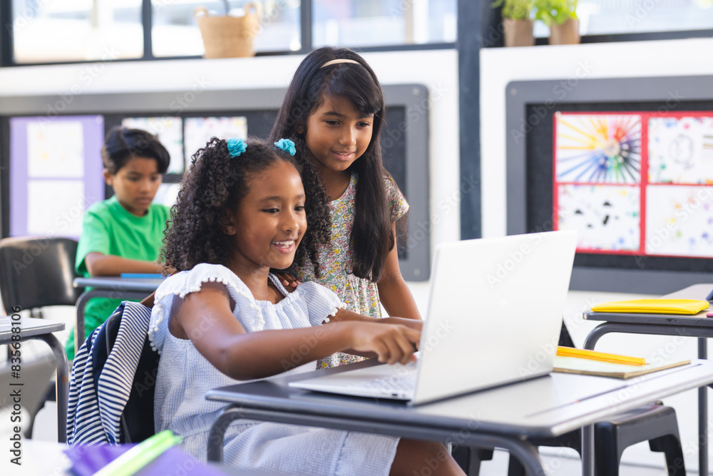 © Wavebreak Media - Two biracial girls, one in white dress, use a laptop in a classroom © Wavebreak Media - Two biracial girls, one in white dress, use a laptop in a classroom