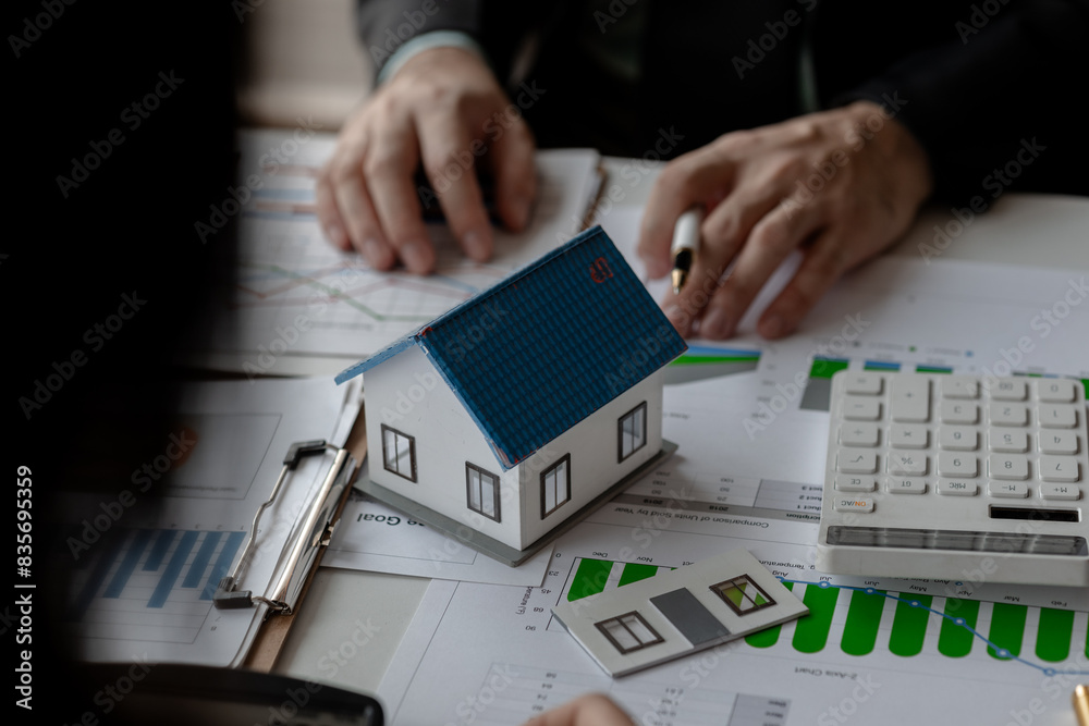 Fototapeta premium accommodation agency and client are planning together about finance because the client wanted to buy a house, meeting in property office with expert of how to find the best house for rent