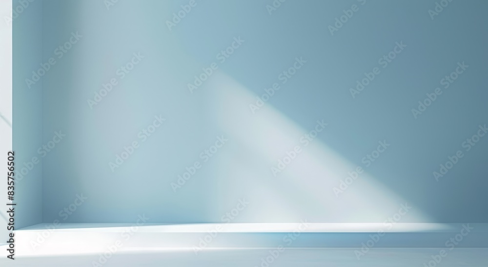 Abstract light blue background with a soft gradient, a white spotlight and rays of light on an empty studio room wall for a product display presentation design Abstract light blue background with a soft gradient, a white spotlight and rays of light on an empty studio room wall for a product display presentation design