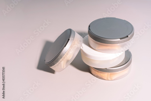 Plastic jars with bags of non-smoking tobacco product under hard light. photo