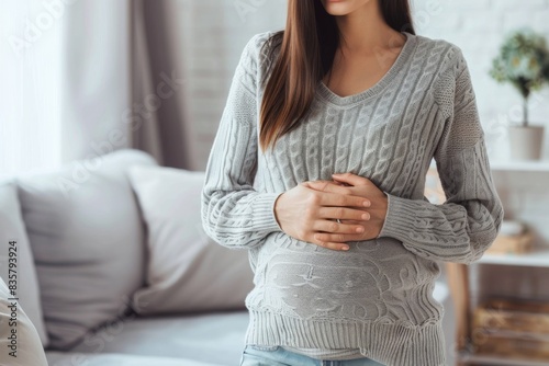 Pregnant woman holds her belly. Close up of her holding her stomach