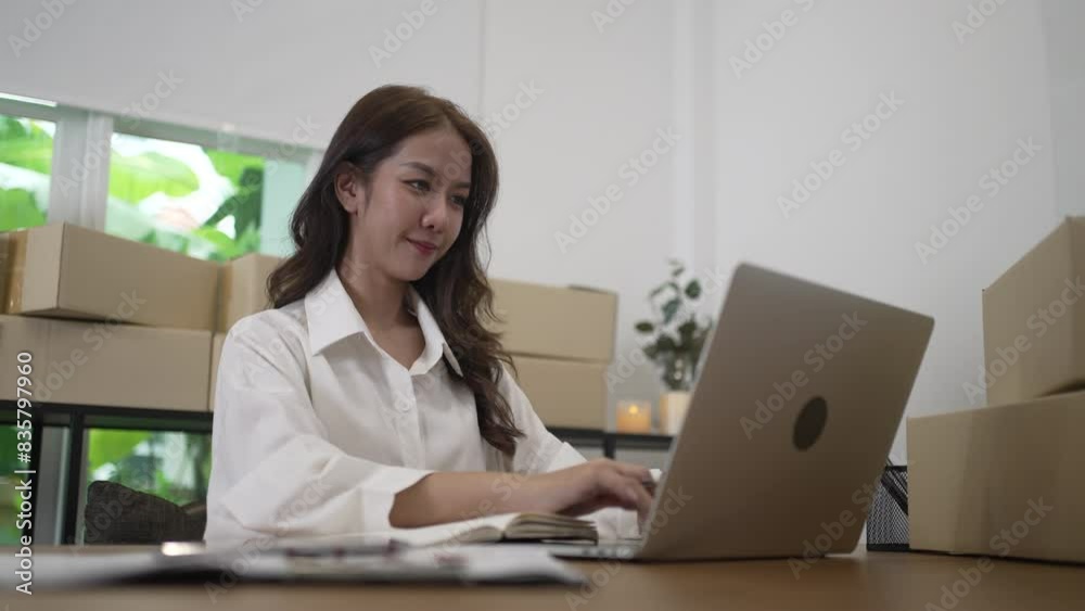 Young female entrepreneur is packing merchandise at home. Young female entrepreneur is packing merchandise at home.
