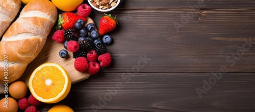 Breakfast spread featuring nutritious food on a rustic wooden surface with ample copy space image. Top view arrangement is beautifully captured in a flat lay style.